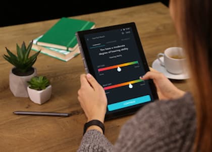 Unlock the power of remote hearing care webinar | Audiology solution for COVID-19 Female conducting a remote hearing screening test using the hearX Self Test Kit