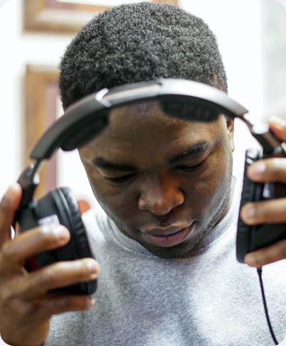tester fitting a heartest occupation health headphone onto a user's head