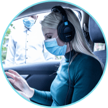 Curb-side hearing testing Low-touch, curb-side hearing assessment conducted by female